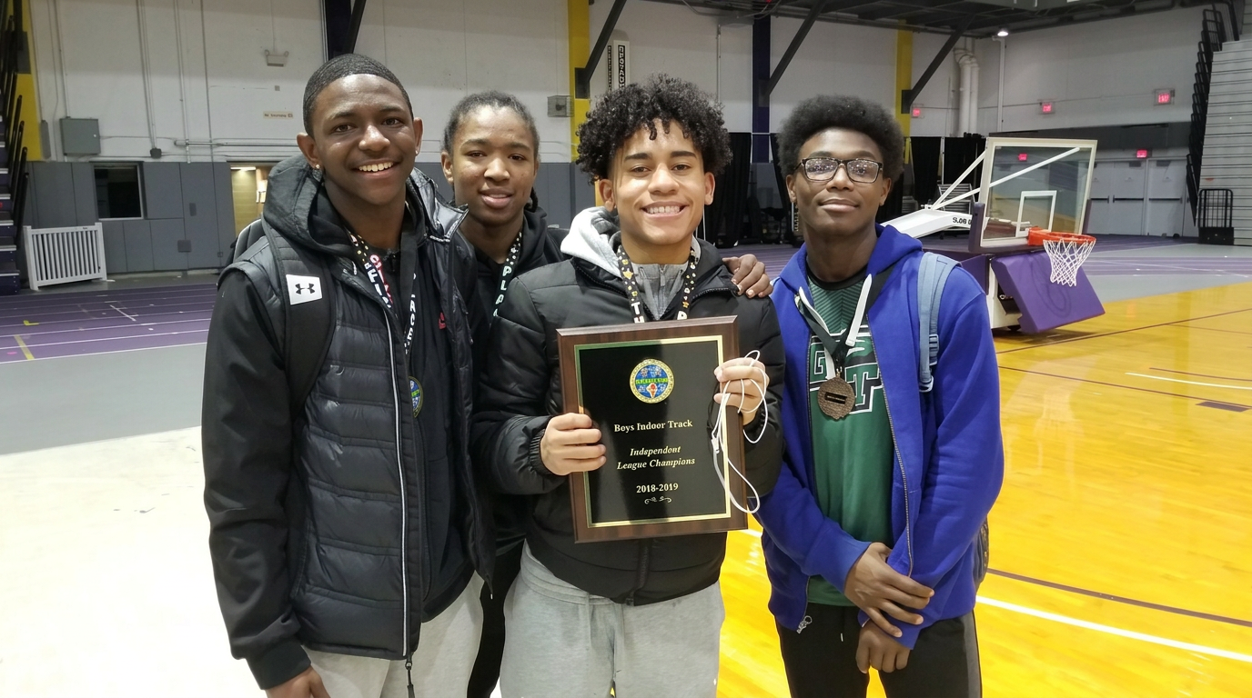 Green Tech athletes holding the 2018-2019 Boys Indoor Track Independent League Champions plaque