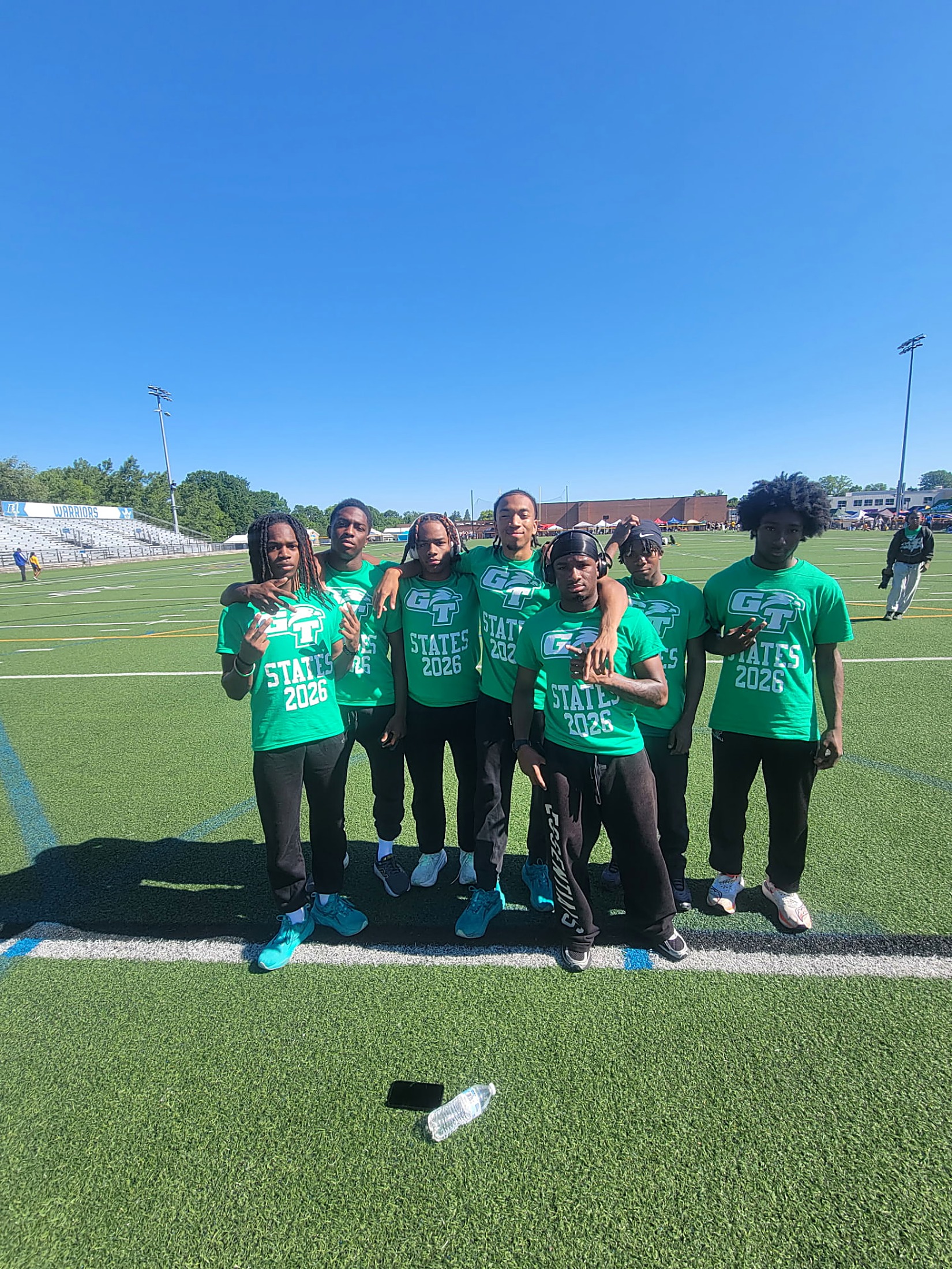 Green Tech Eagles track and field athletes in GT States 2026 shirts on the field at the New York State championship meet