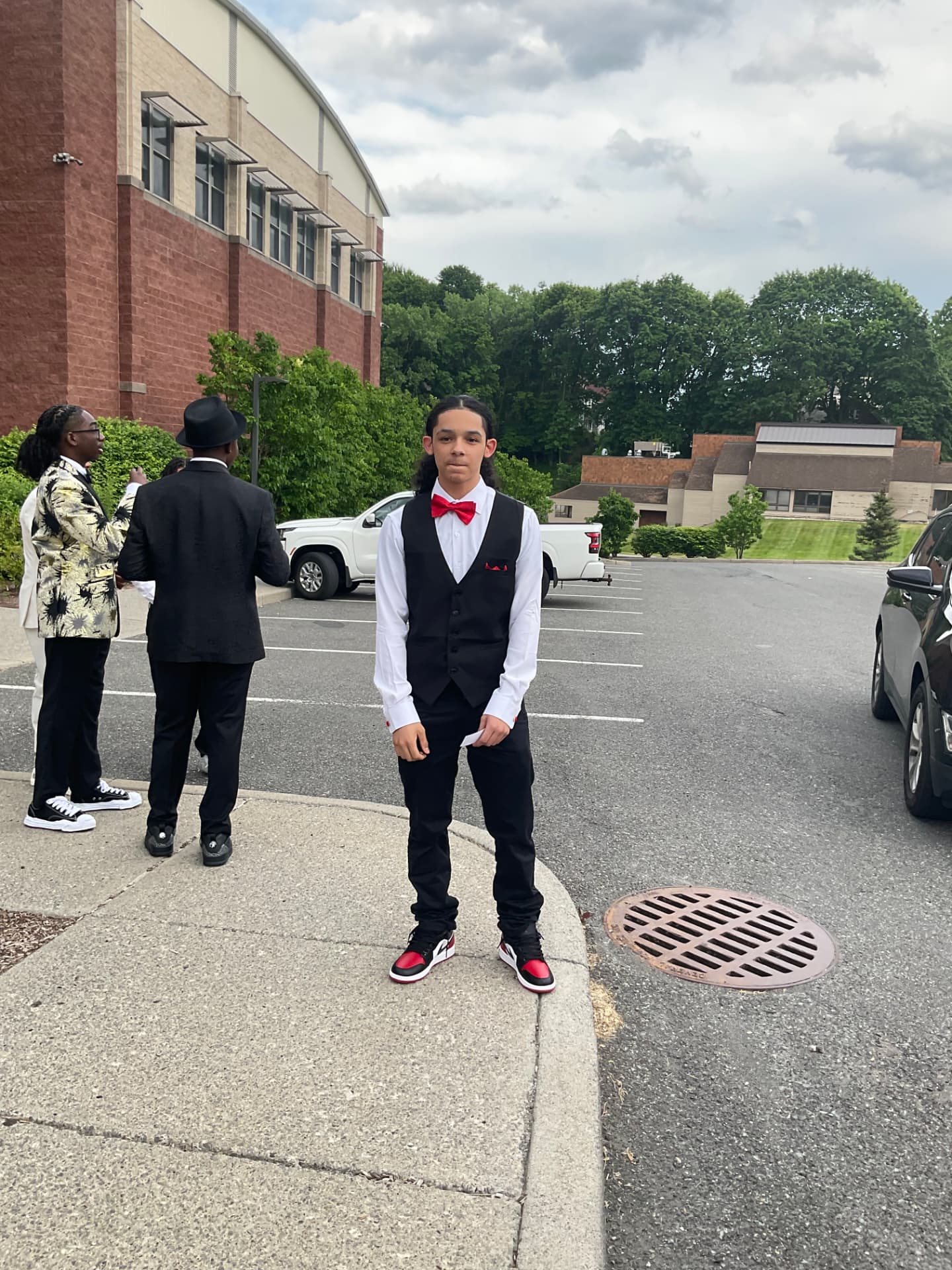 A Green Tech High student in a vest and bow tie before the formal