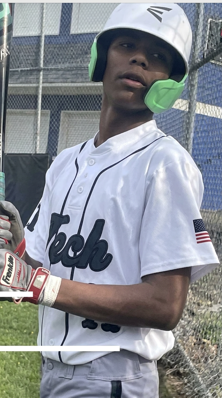 Green Tech High Eagles baseball player at bat in a white and green uniform