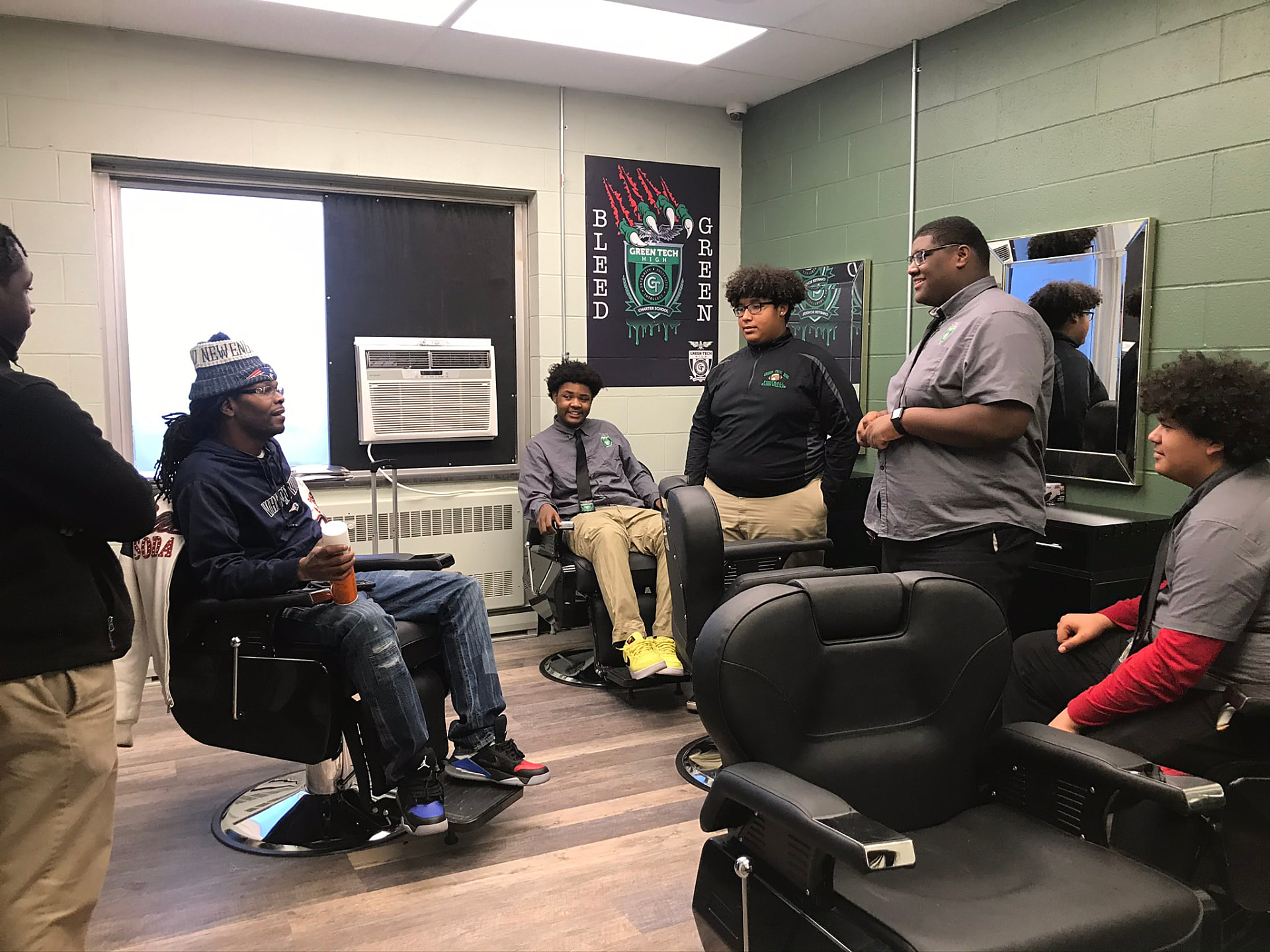 Green Tech High students and their barbering instructor in the school's on-campus barbershop classroom in Albany, NY