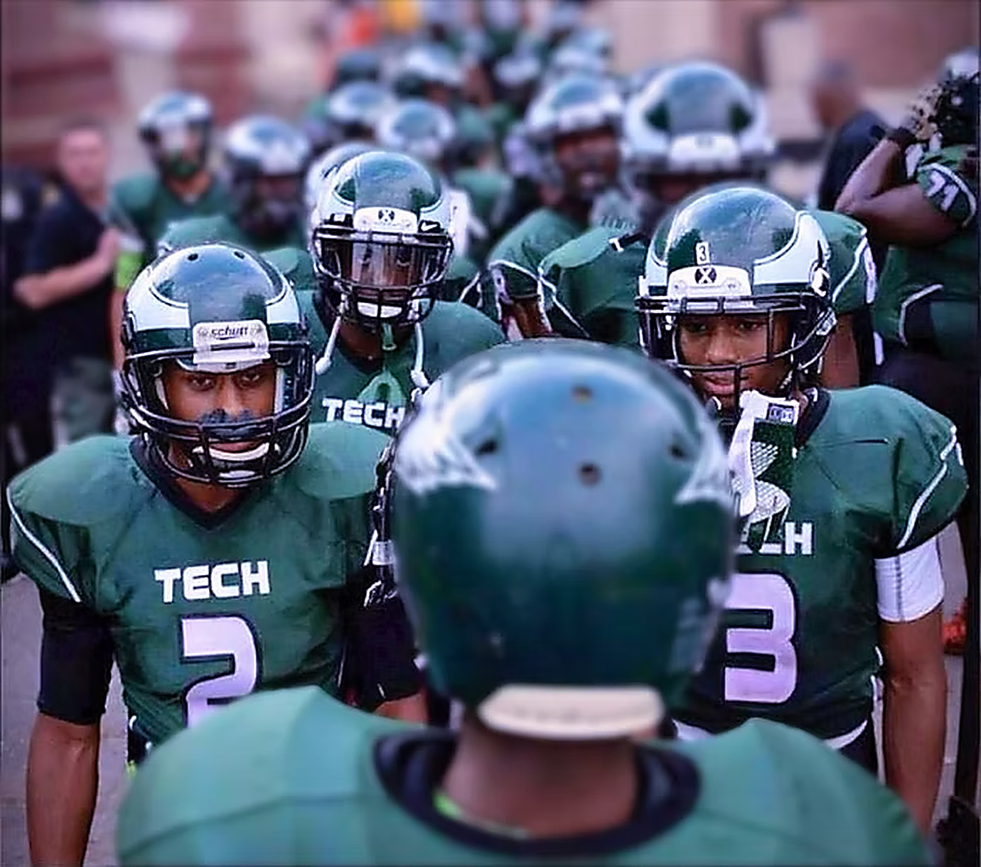 Green Tech student-athletes making an entrance onto the court before a game