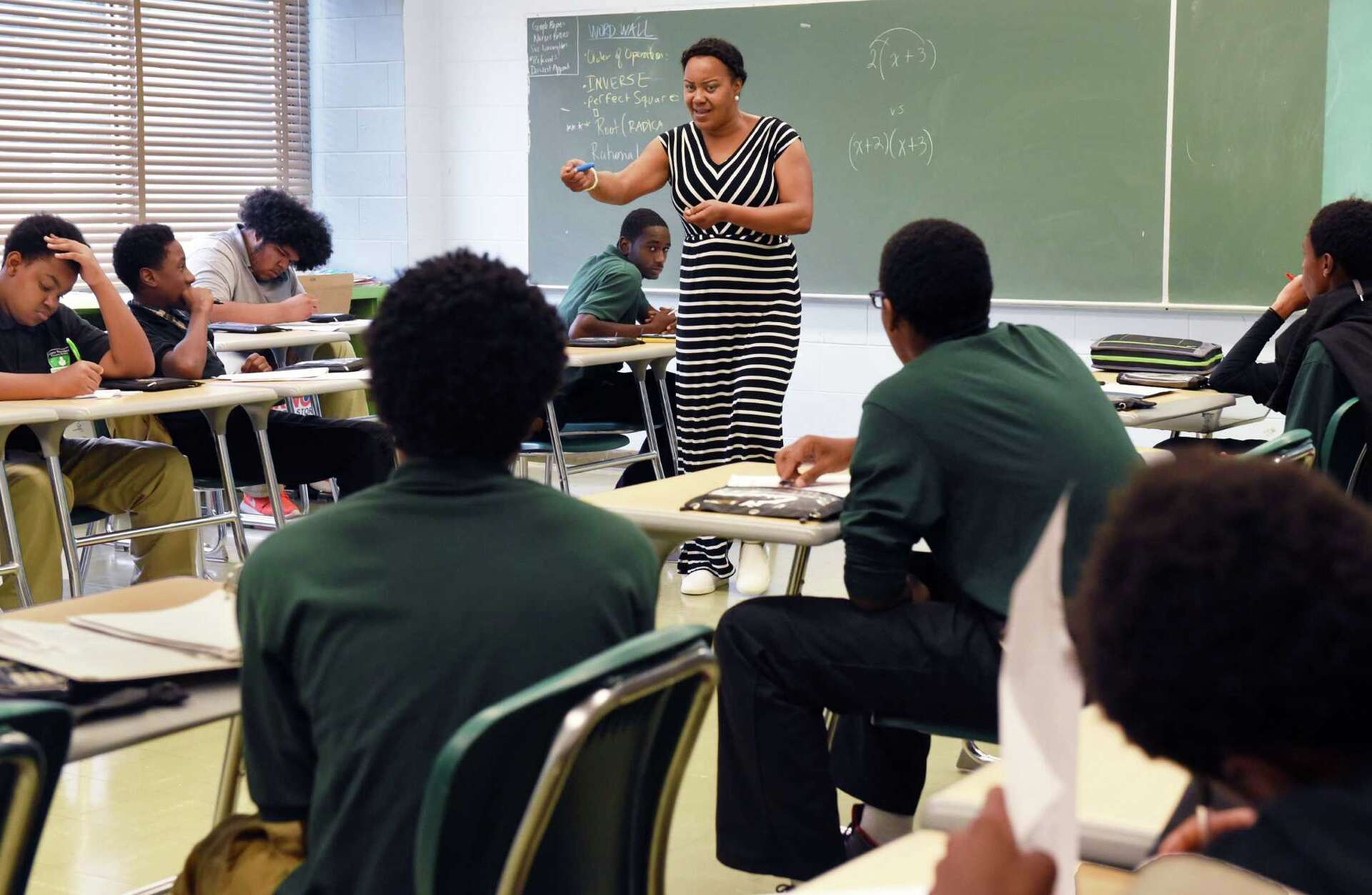 Teacher mentoring students in a Green Tech High classroom